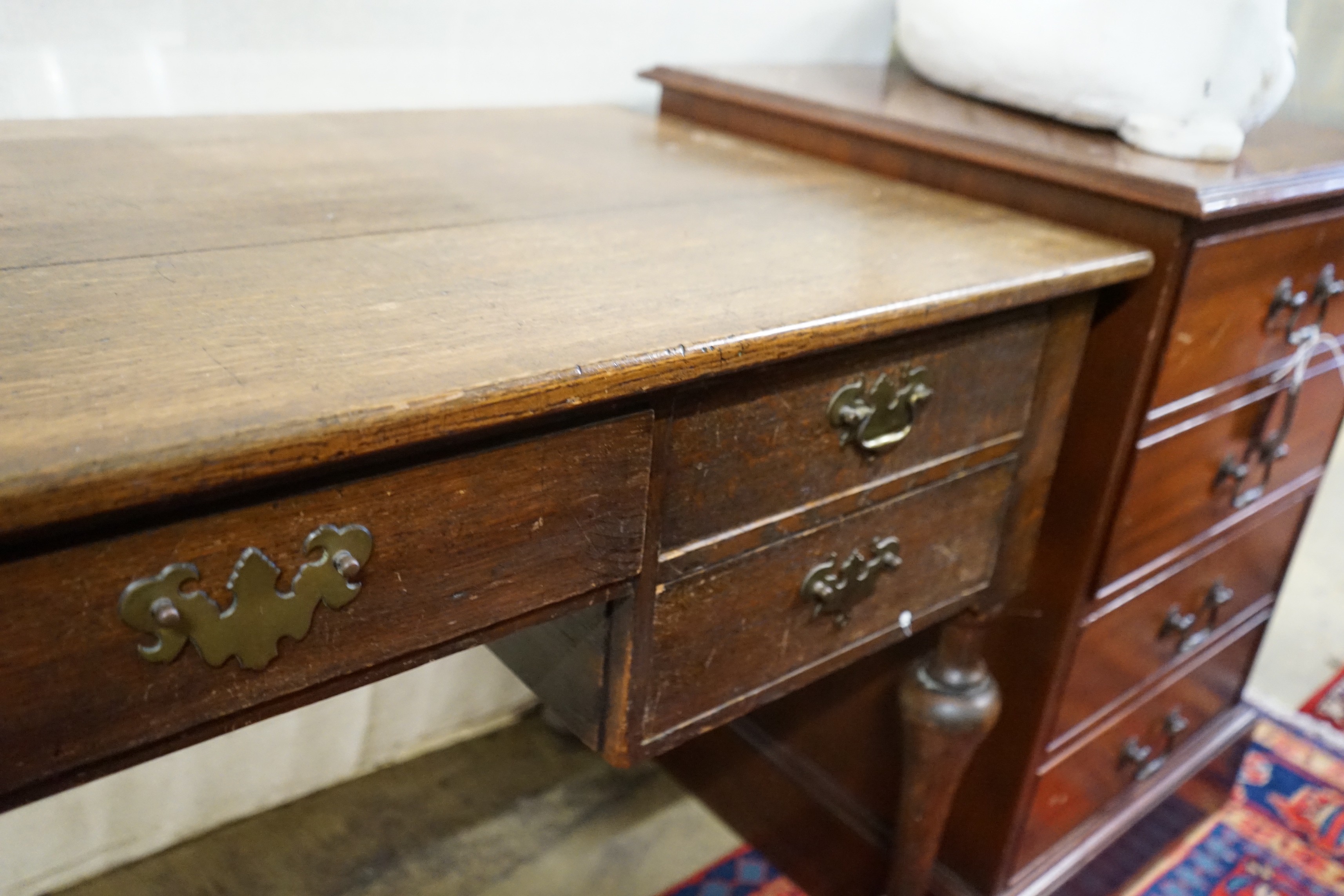 A 1920's oak kneehole desk, length 122cm, 61cm, height 76cm